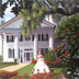 Southern Belle in front of plantation home