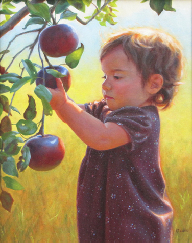 Little girl picking an apple